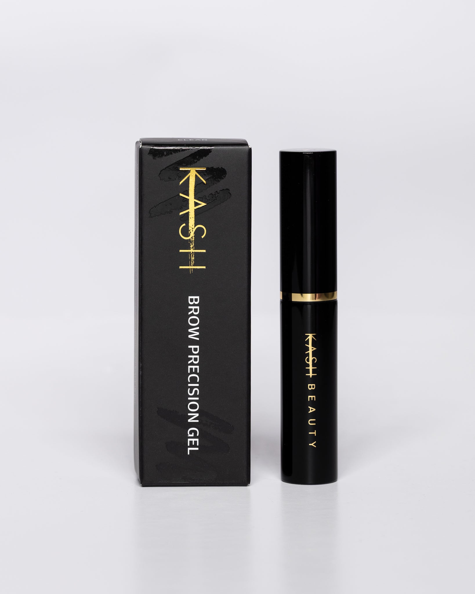 Black brow gel with gold band and text by KASH Beauty, shown with matching sleek black box, front view on white background
