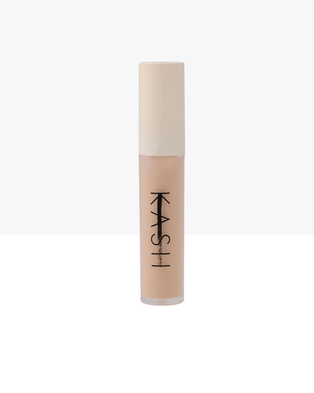 Light beige liquid concealer in clear tube with white cap by KASH, featuring bold black vertical branding, front view on white background