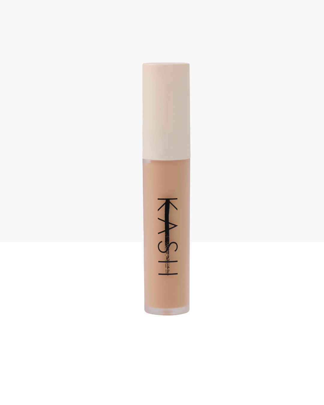 Light beige liquid concealer by KASH in clear tube with white cap and black logo, front view
