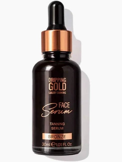 A bottle of Dripping Gold Luxury Earning Face Serum in Bronze, featuring a dark brown glass bottle, a metallic bronze dropper collar, and a black dropper top, set against a clean white background with a soft shadow.