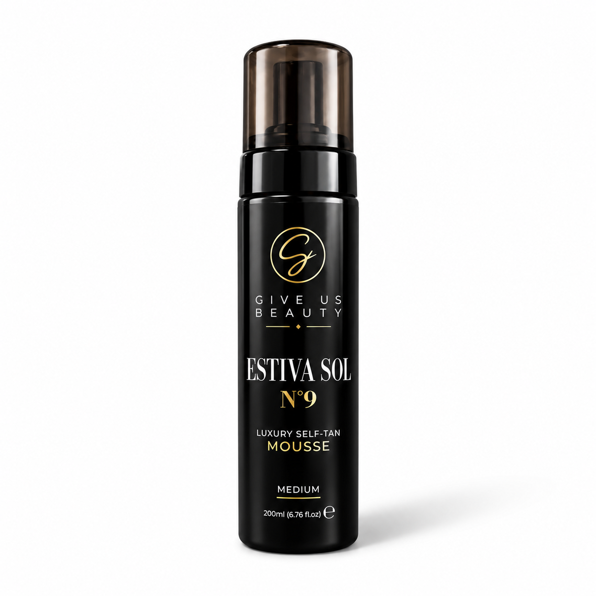 A black cylindrical pump bottle of Give Us Beauty Estiva Sol No. 9 Luxury Self-Tan Mousse, featuring a dark brown translucent cap and gold and white lettering, set against a plain white background.