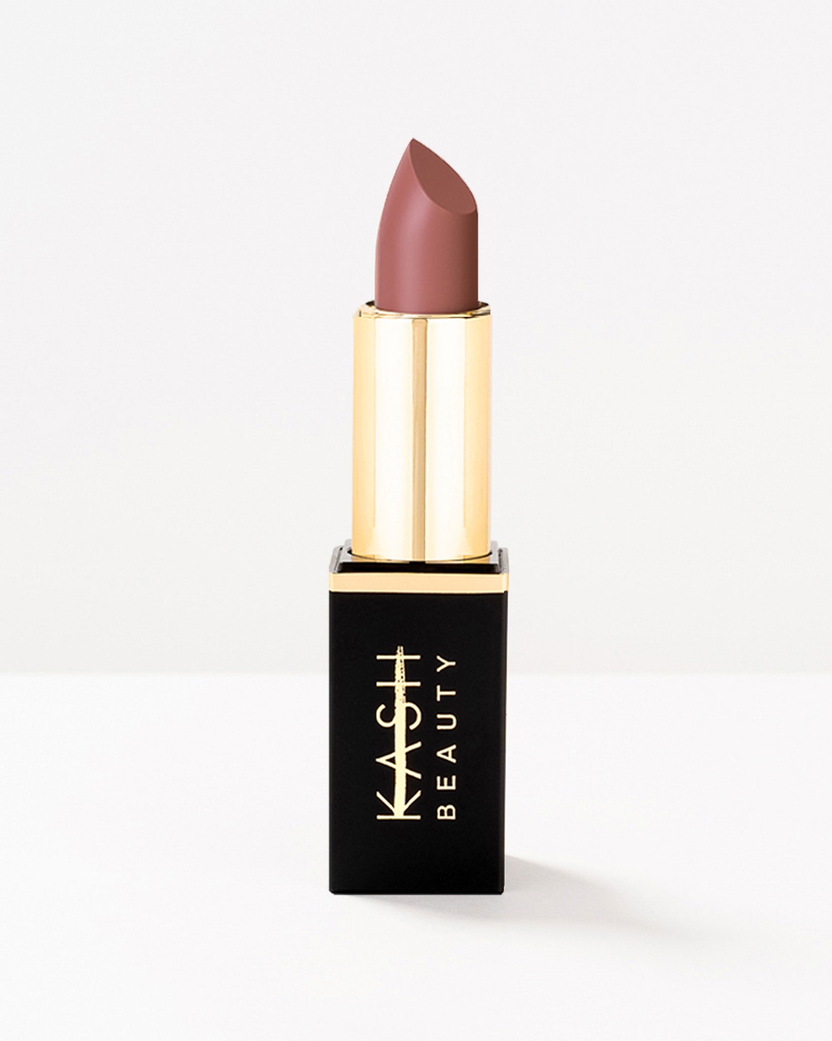 Matte taupe lipstick by KASH Beauty with gold cap and black rectangular case, front view on white background