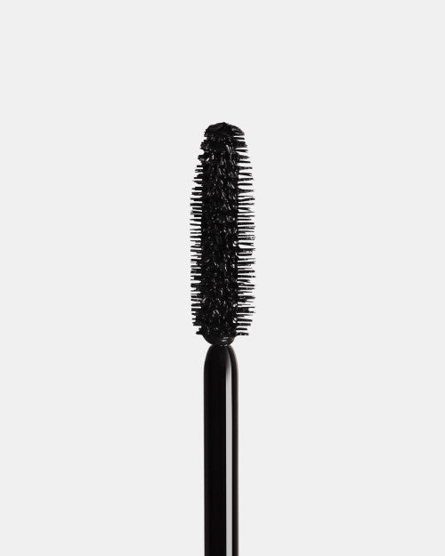 Black mascara brush on a light gray background give us beauty and inglot