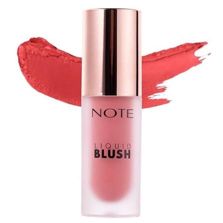 A bottle of NOTE Liquid Blush in a coral pink shade, featuring a metallic rose gold cap and a matching coral pink product smear behind it on a white background.
