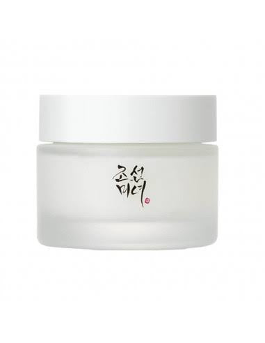 Beauty of Joseon dynasty cream. A frosted glass cosmetic jar with a white lid, featuring black Korean calligraphy and a small red seal on the front, set against a plain white background. At give us beauty