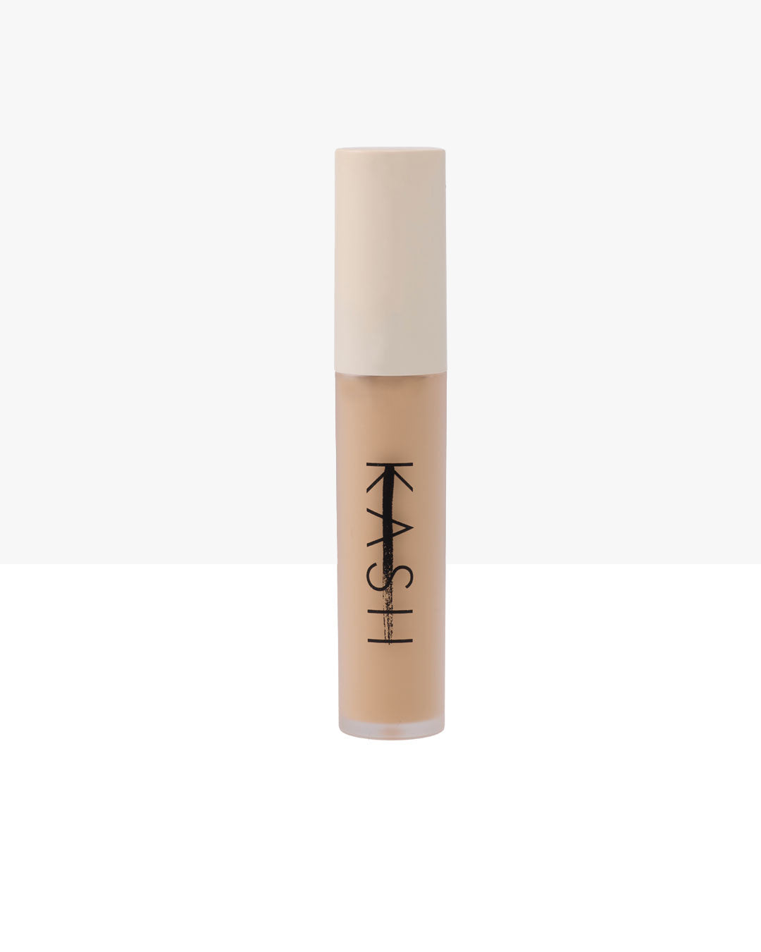 Light beige liquid concealer by KASH in clear tube with matte cream cap and bold black logo, front view