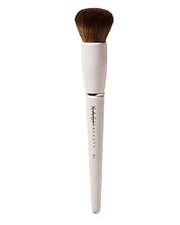 Cream-colored foundation brush with dense brown bristles and white handle by KASH Beauty, featuring a gold band and minimalist design, shown in front view.