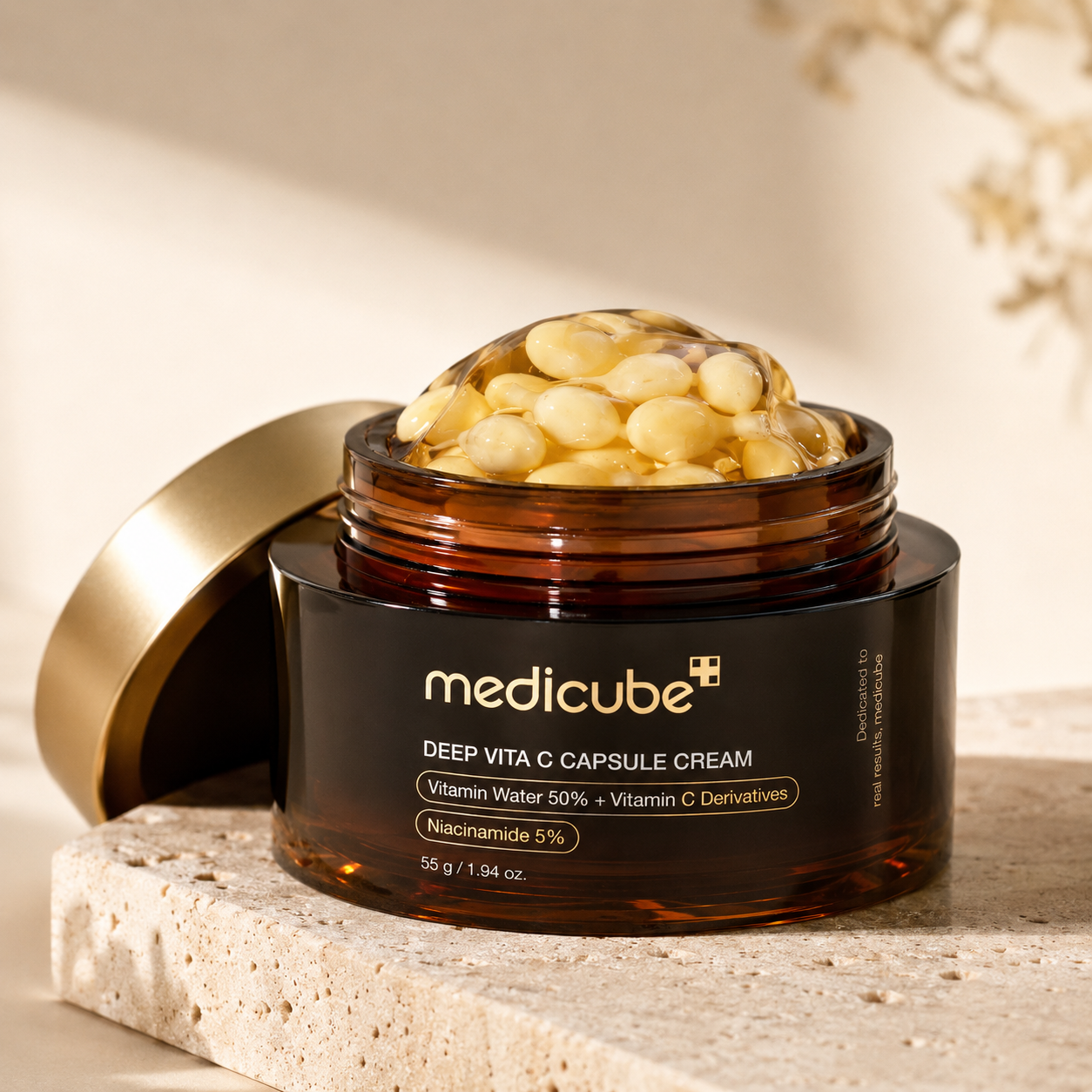 Medicube Deep Vita C Capsule Cream jar with gold lid on a neutral background