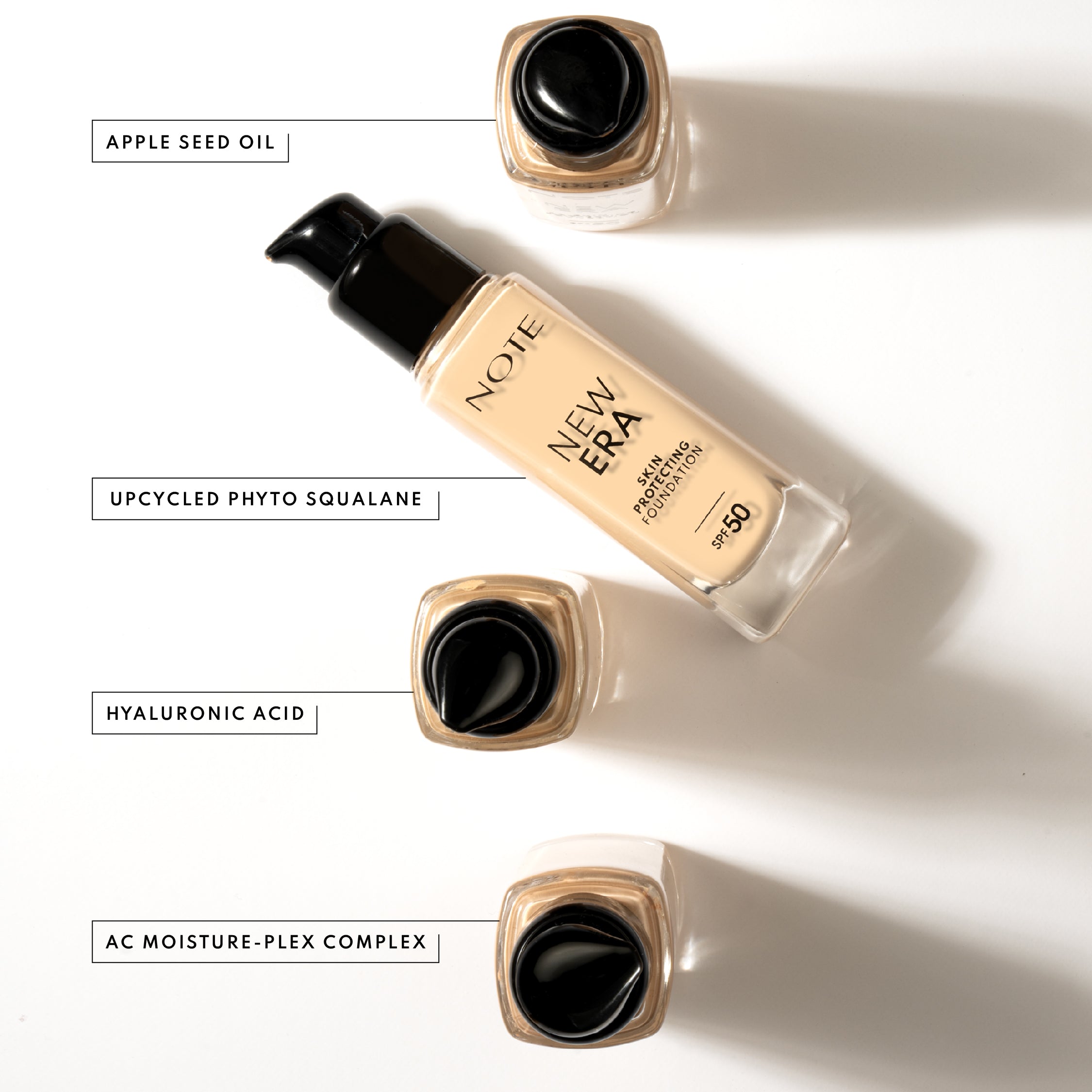 Light beige foundation in clear glass bottle with black pump, by NOTE, shown with ingredient labels on white background, top-down view