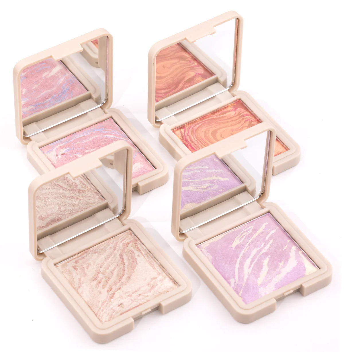 Note Marble backed blusher. Set of four compact makeup products with colorful shades on a white background