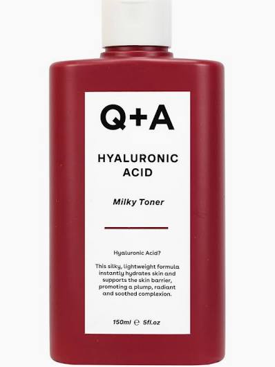 Red bottle of Q+A Hyaluronic Acid Milky Toner on a white background