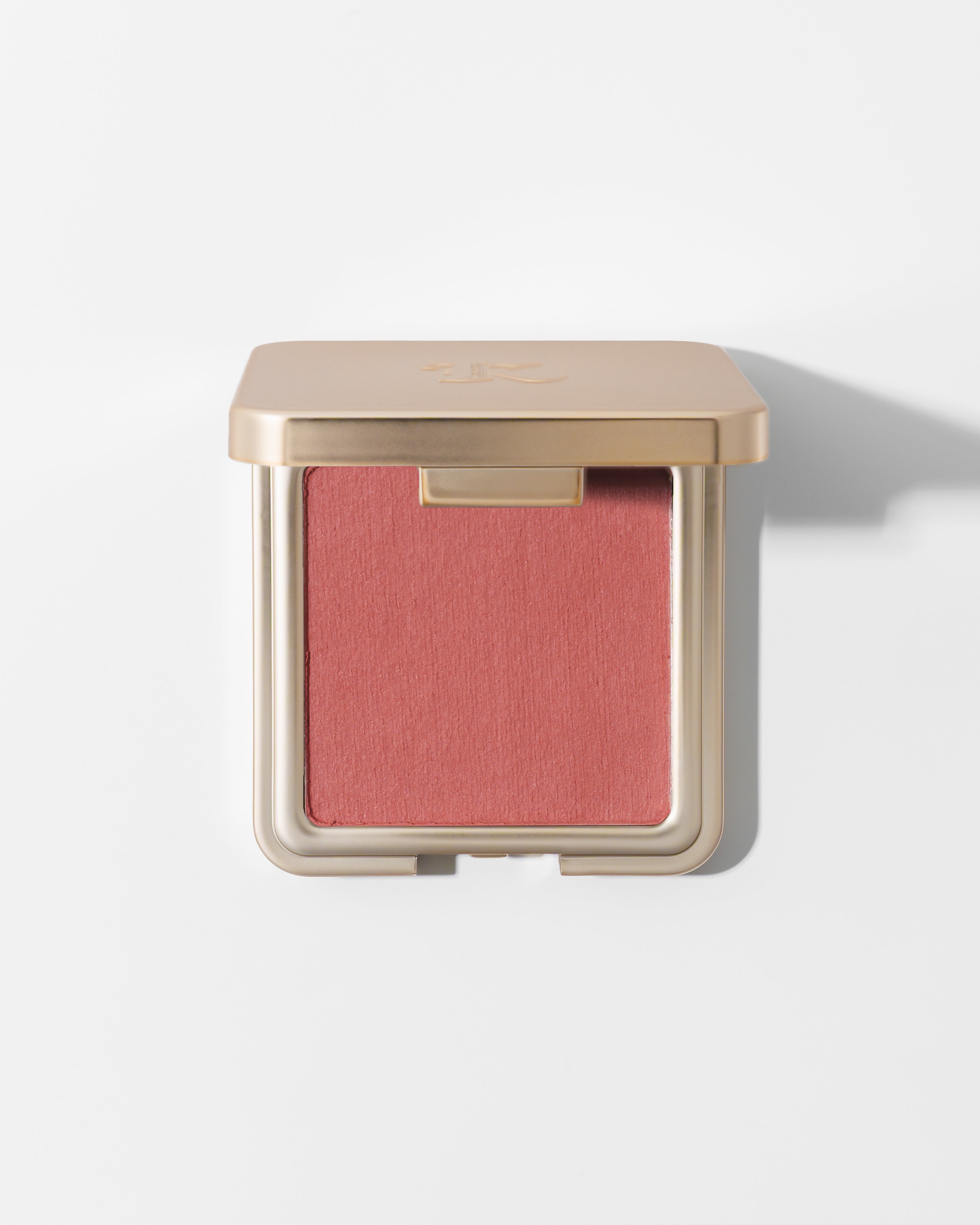 Soft suede blush in warm rose tone by KASH Beauty, in square gold compact with matte finish, front view