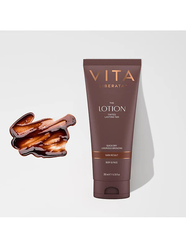 Vita Liberata lotion tube with a sample of dark chocolate on a white background